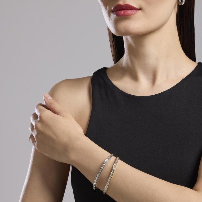 Bracciale rigido in acciaio dorato e zirconi